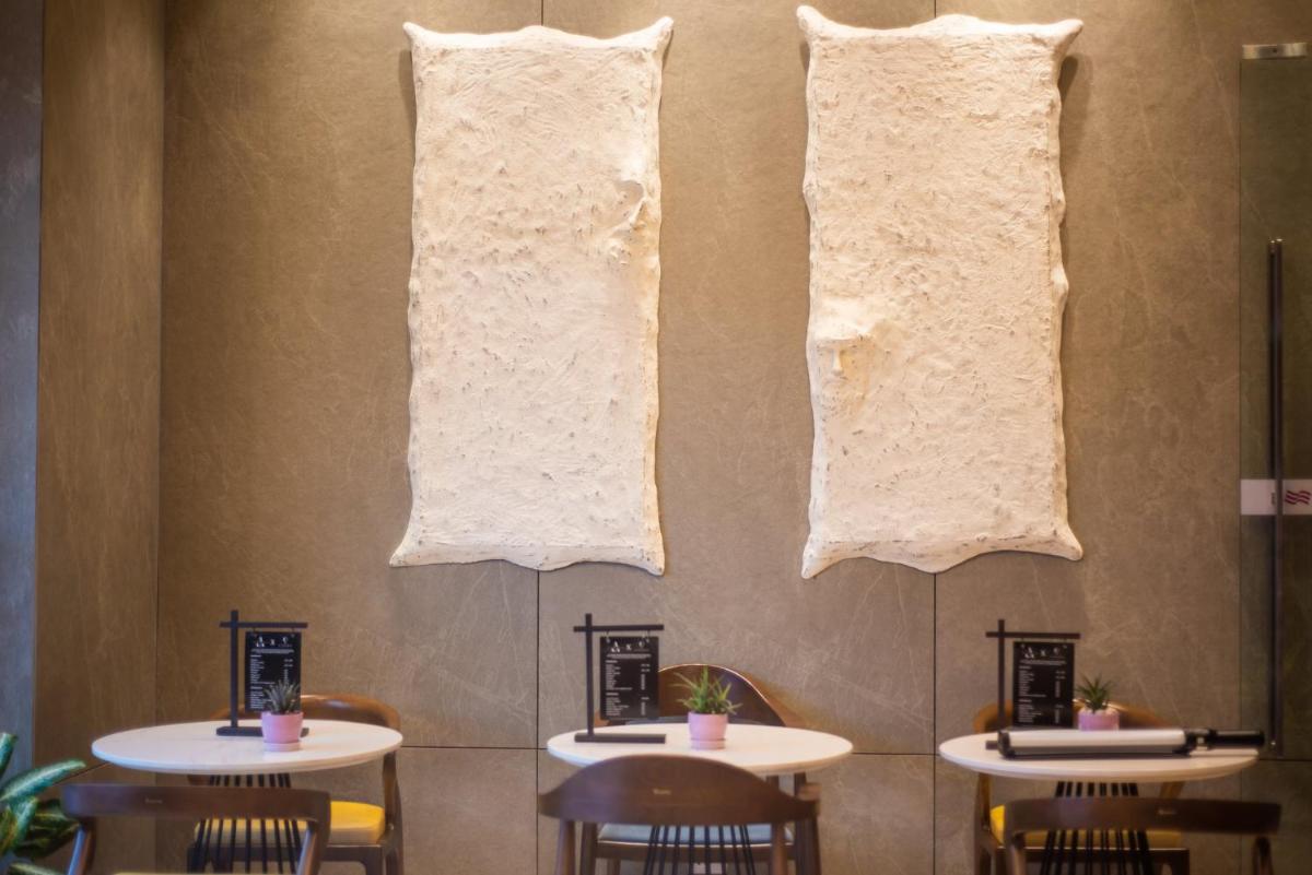 a row of tables in a restaurant with towels at Crowne Plaza Today Gurugram by IHG in Gurgaon