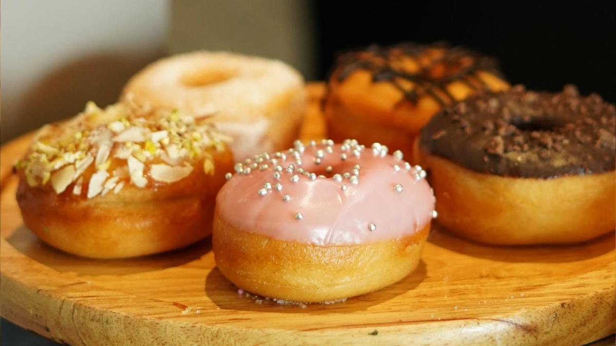 a bunch of donuts sitting on a wooden board at InterContinental Marine Drive Mumbai by IHG in Mumbai