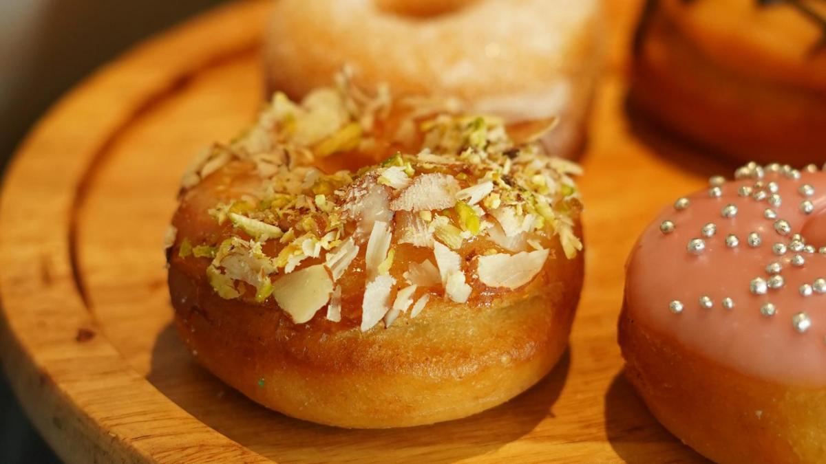 a group of donuts sitting on a wooden plate at InterContinental Marine Drive Mumbai by IHG in Mumbai