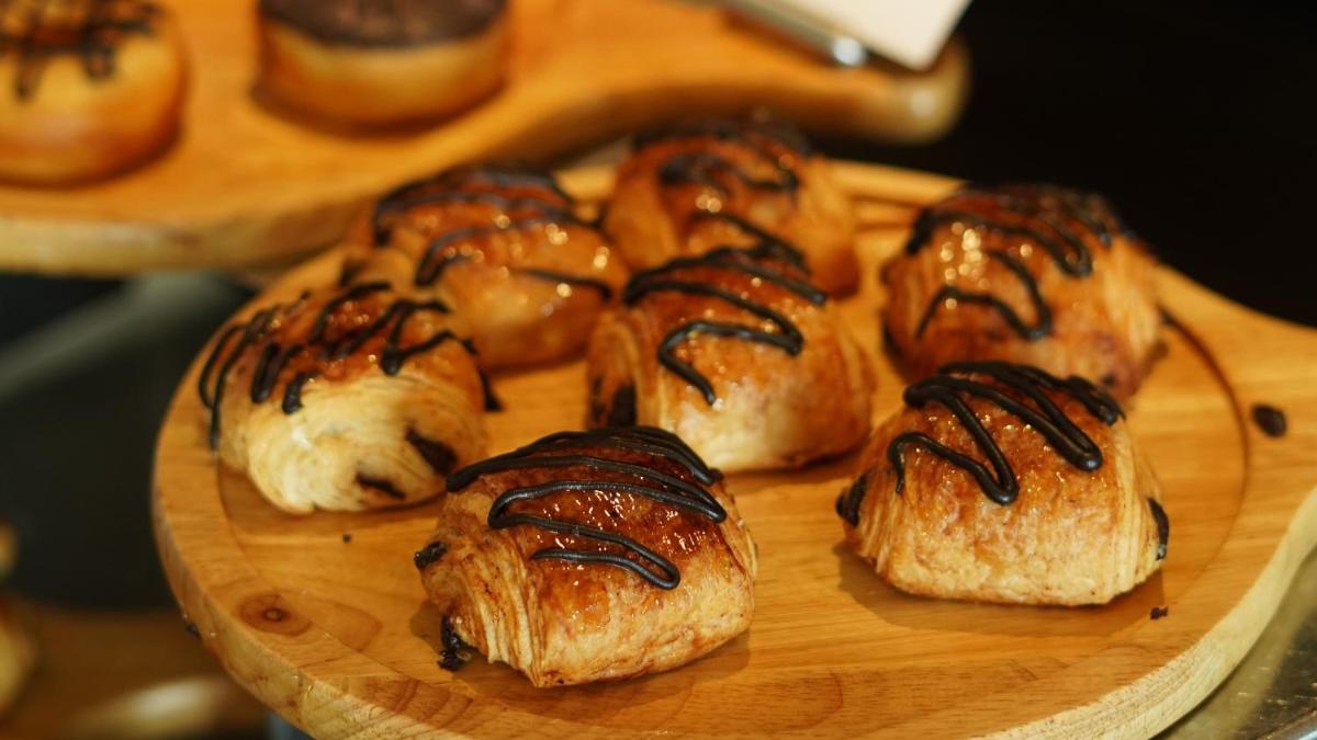 a bunch of pastries on a wooden plate at InterContinental Marine Drive Mumbai by IHG in Mumbai