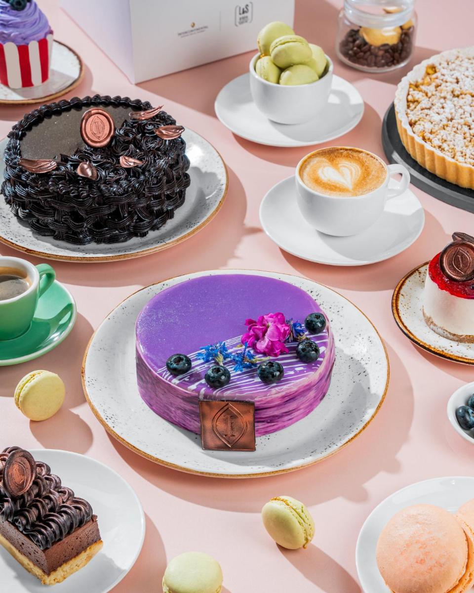 a table with cakes and cups of coffee and desserts at InterContinental Marine Drive Mumbai by IHG in Mumbai