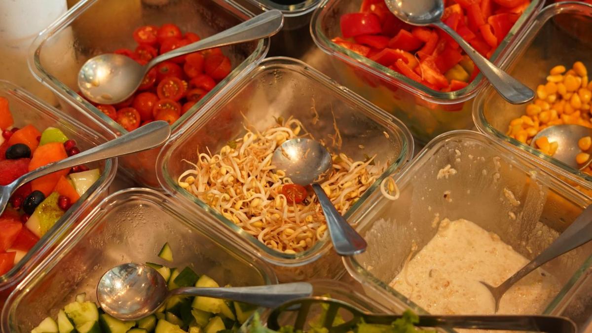 a bunch of plastic containers filled with food with spoons at InterContinental Marine Drive Mumbai by IHG in Mumbai