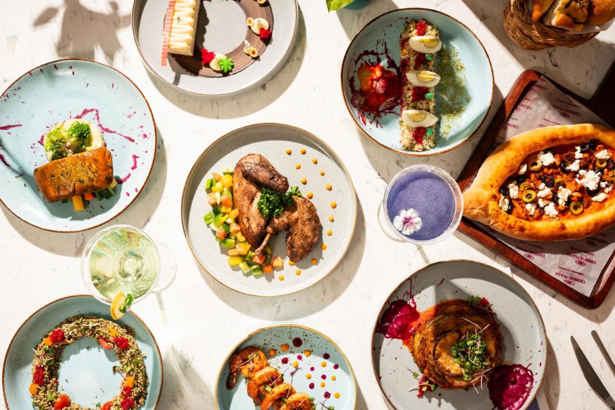 a bunch of plates of food on a table at Crowne Plaza Ahmedabad City Centre by IHG in Ahmedabad