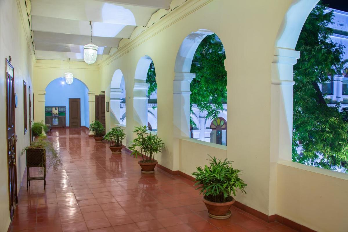 a hallway with potted plants in a building at The Grand Imperial - Heritage Hotel in Agra