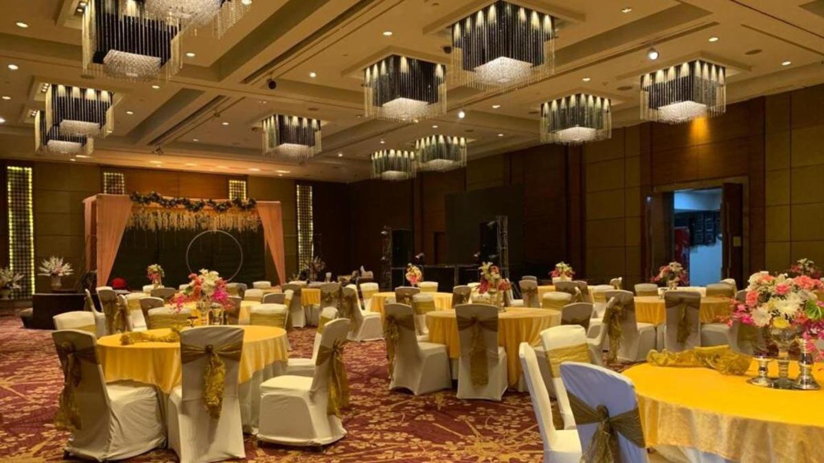 a banquet hall with yellow tables and white chairs at Crowne Plaza Today Gurugram by IHG in Gurgaon