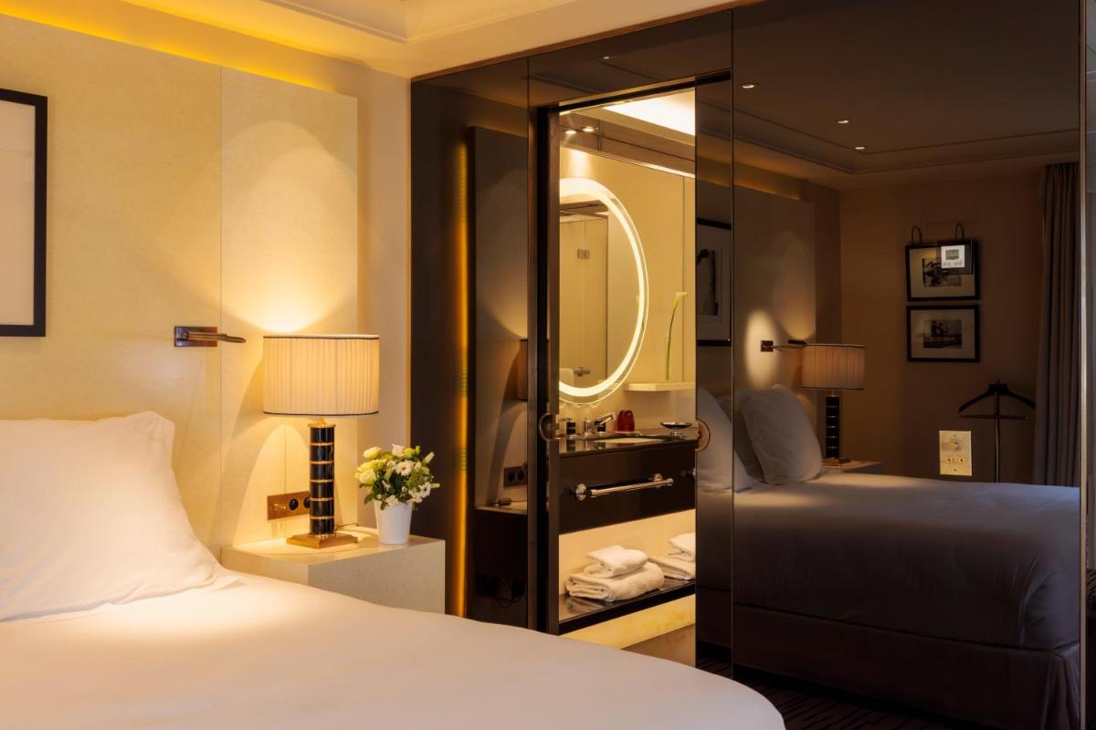 Un ou plusieurs lits dans un hébergement de l'établissement Hotel Montaigne