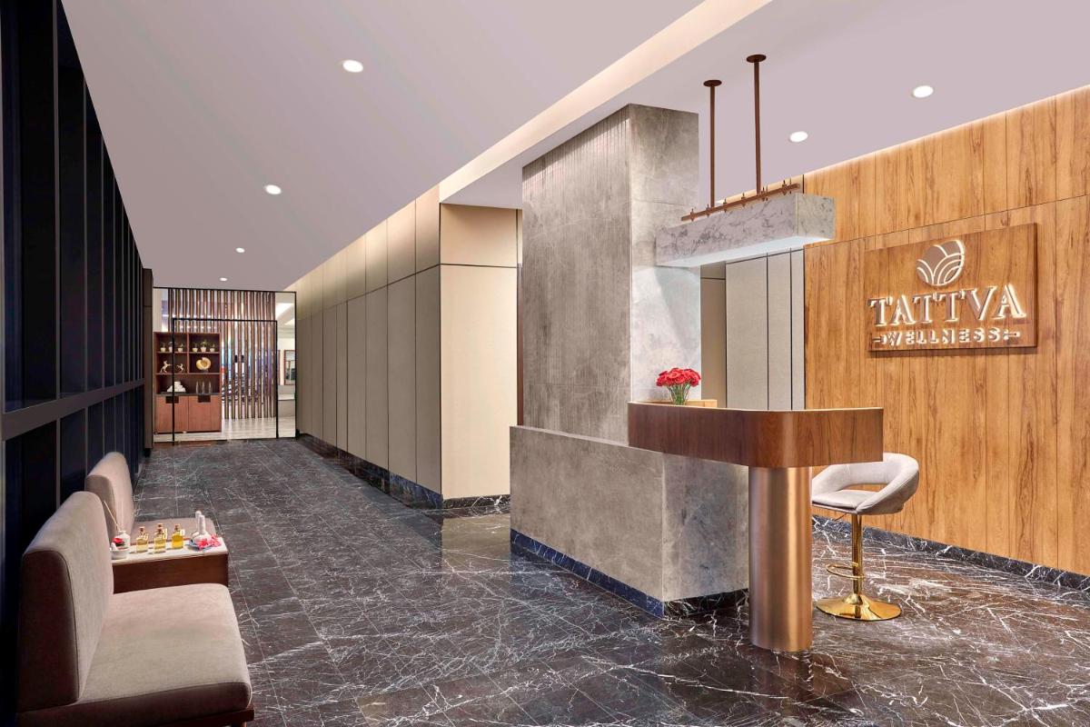 a lobby of a hotel with a chair and a table at Hilton Bengaluru Embassy Manyata Business Park in Bengaluru