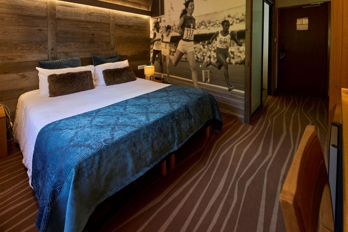 Un ou plusieurs lits dans un hébergement de l'établissement Hôtel Le Grand Tétras