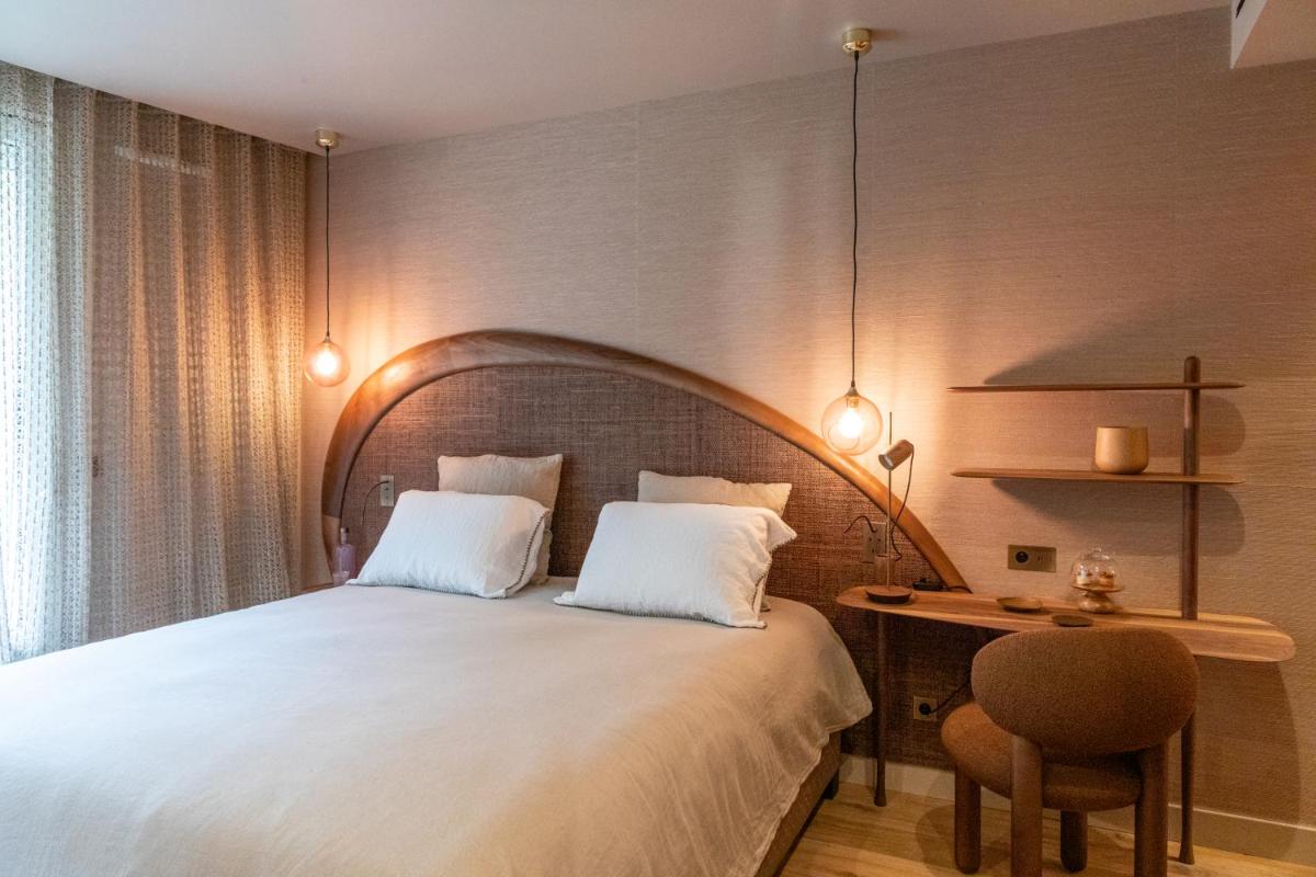 Un ou plusieurs lits dans un hébergement de l'établissement Yndo Hôtel