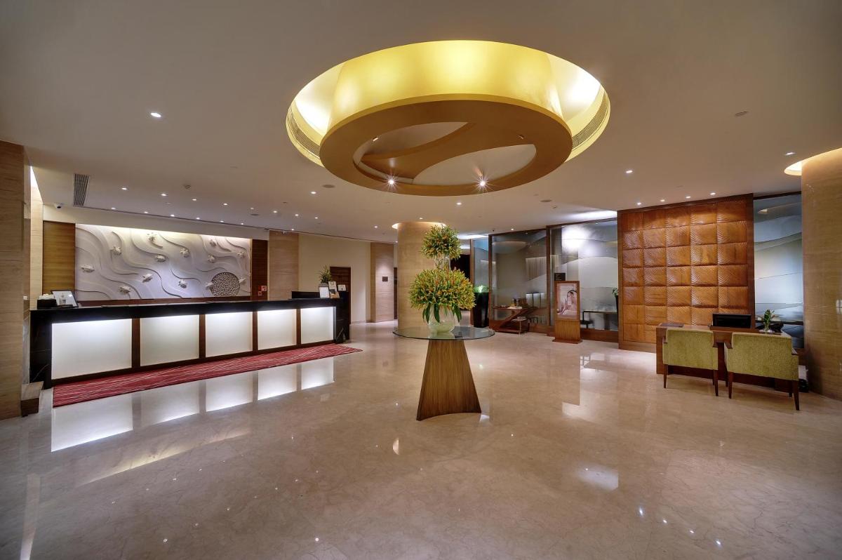 a large lobby with a large gold ceiling at Vivanta Goa, Panaji in Panaji a large lobby with a large gold ceiling at Vivanta Goa, Panaji in Panaji