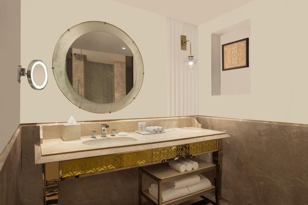 a bathroom with a sink and a mirror at ITC Narmada, a Luxury Collection Hotel, Ahmedabad in Ahmedabad