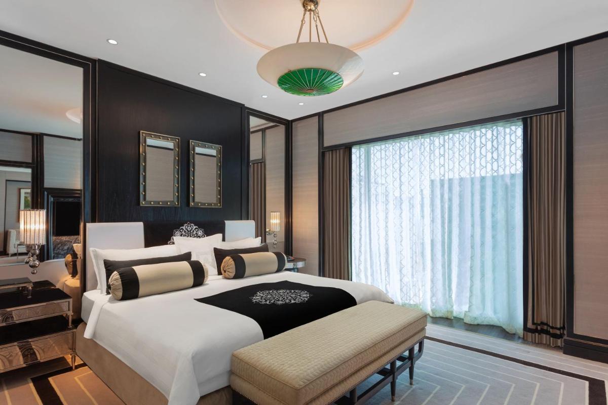 a bedroom with a large bed and a large window at ITC Narmada, a Luxury Collection Hotel, Ahmedabad in Ahmedabad