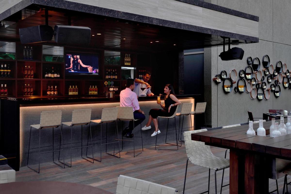 a group of people sitting at a bar at Courtyard by Marriott Pune Hinjewadi in Pune