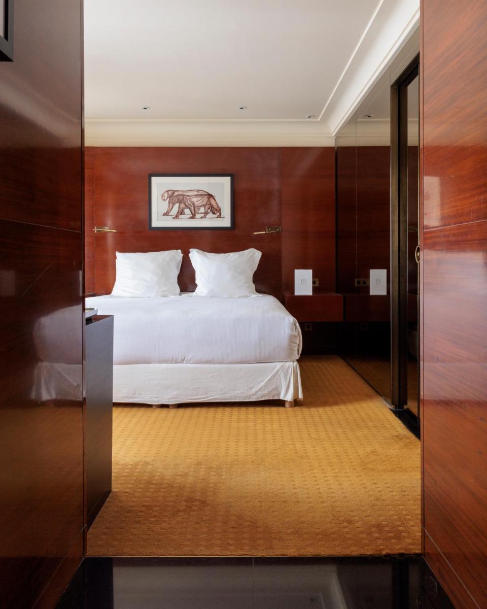 Un ou plusieurs lits dans un hébergement de l'établissement Hotel Montaigne