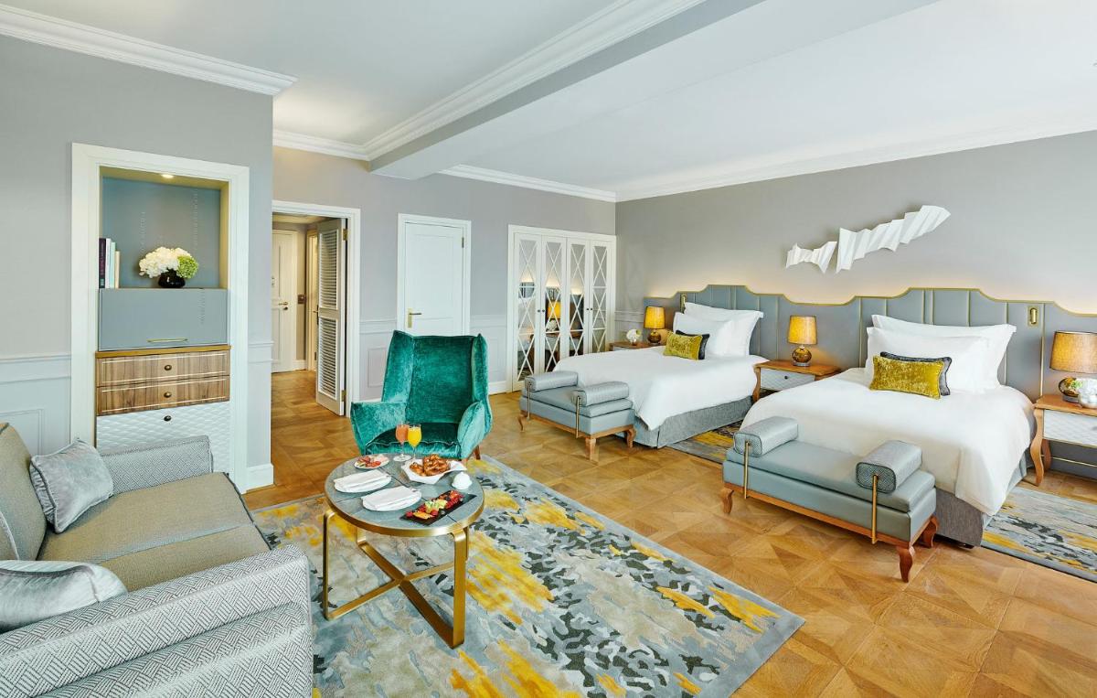 ein Schlafzimmer mit Bett und ein Wohnzimmer in der Unterkunft Mandarin Oriental, Munich in München