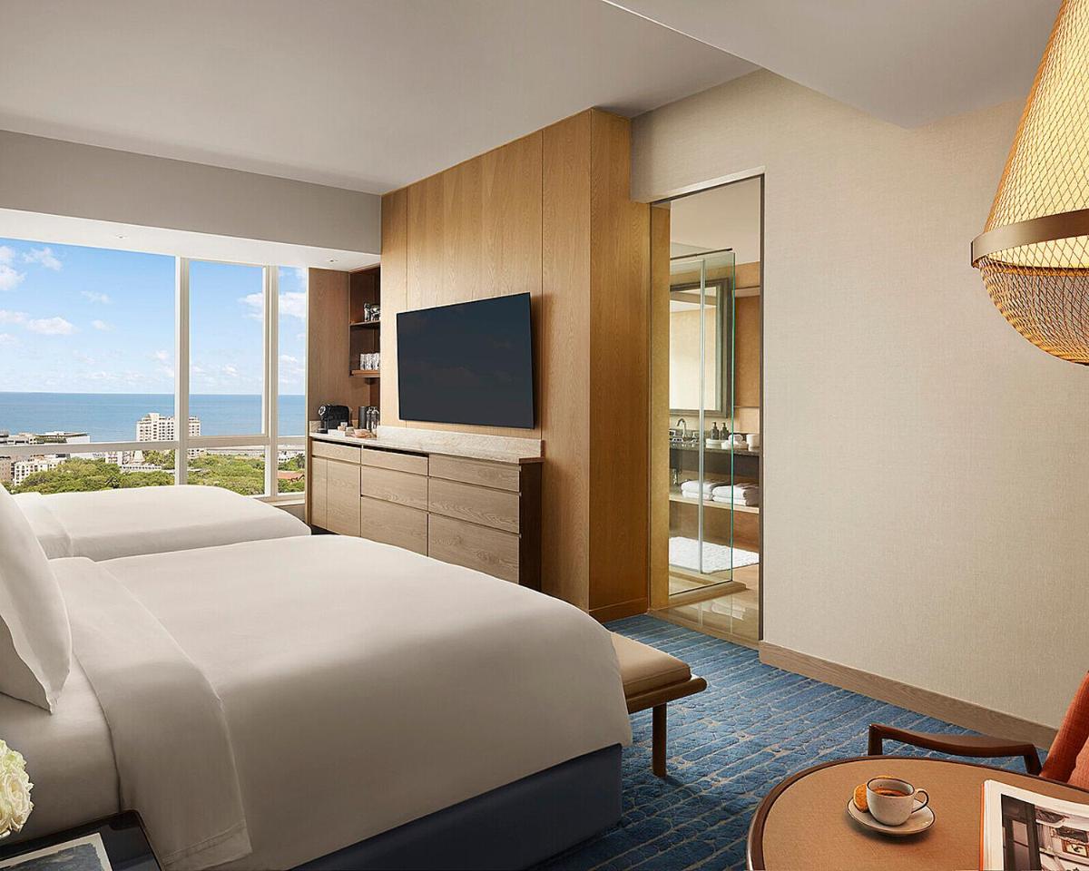 a hotel room with a bed and a television at Four Seasons Hotel Mumbai in Mumbai
