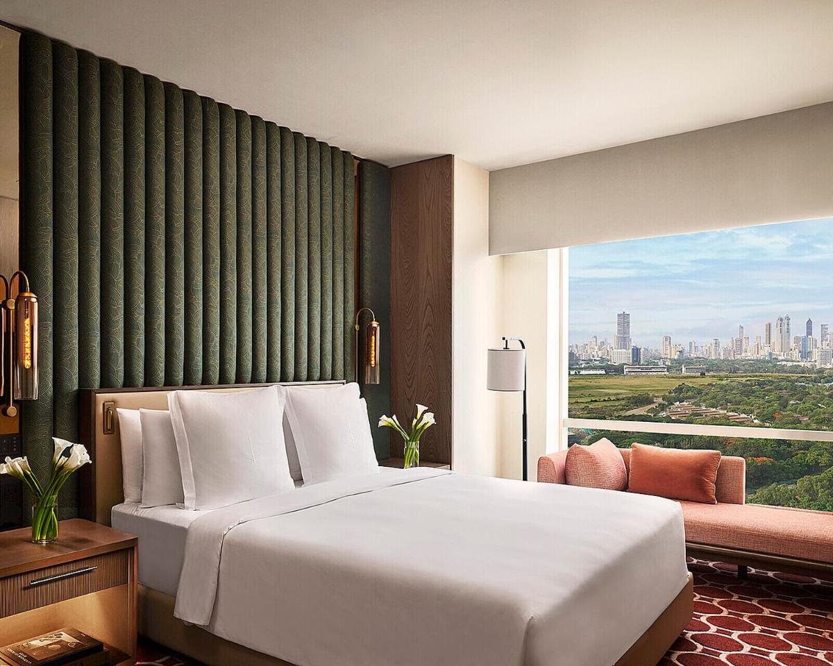 a bedroom with a large white bed and a window at Four Seasons Hotel Mumbai in Mumbai