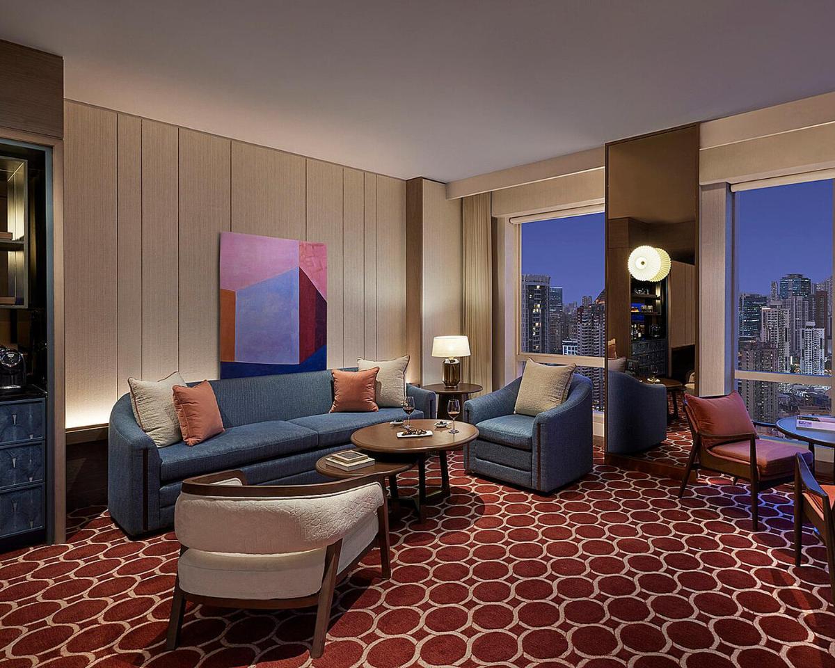 a living room with a couch and chairs and a table at Four Seasons Hotel Mumbai in Mumbai