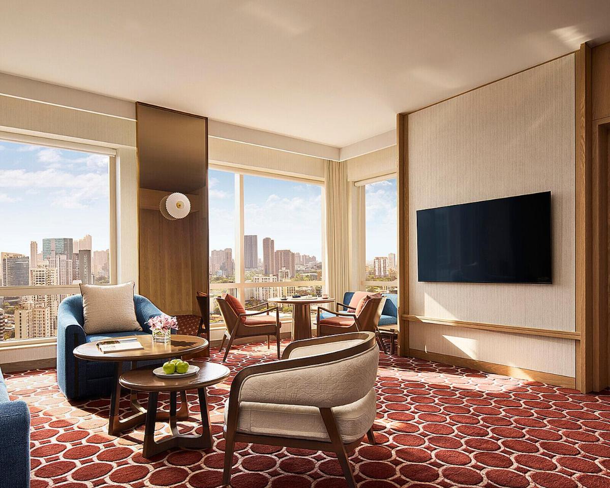 a living room with a view of a city at Four Seasons Hotel Mumbai in Mumbai