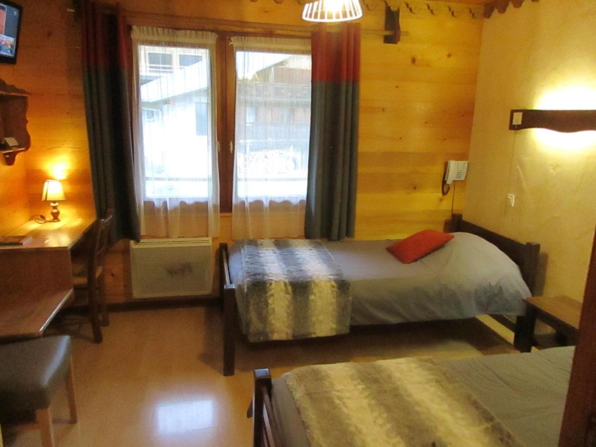 Un ou plusieurs lits dans un hébergement de l'établissement Hotel Le Ferraillon