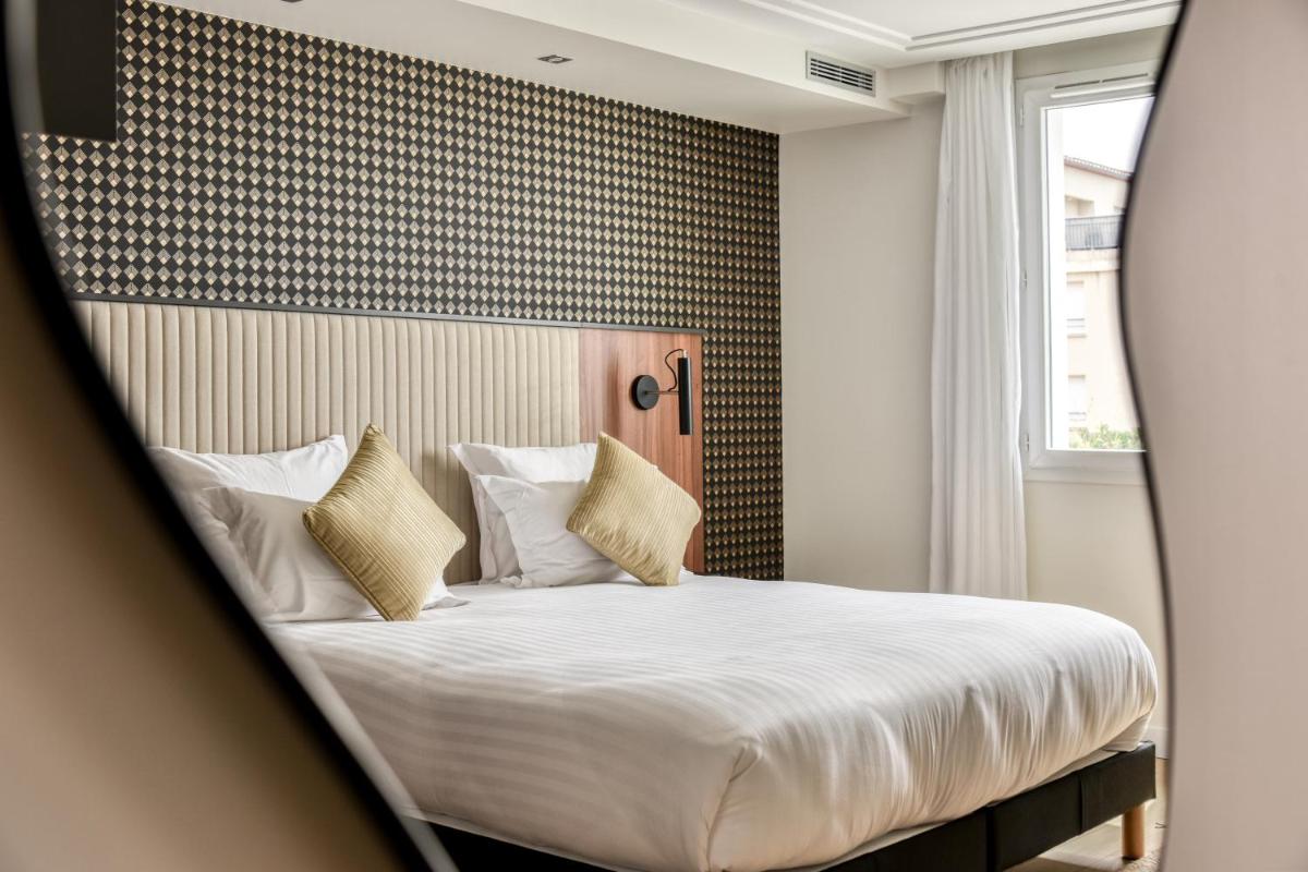 Un ou plusieurs lits dans un hébergement de l'établissement Zenitude Hotel La Valadière, Ascend Hotel Collection