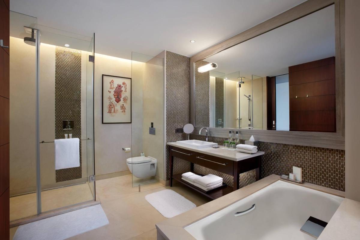 a bathroom with a tub and a sink and a toilet at JW Marriott Hotel Bengaluru in Bengaluru