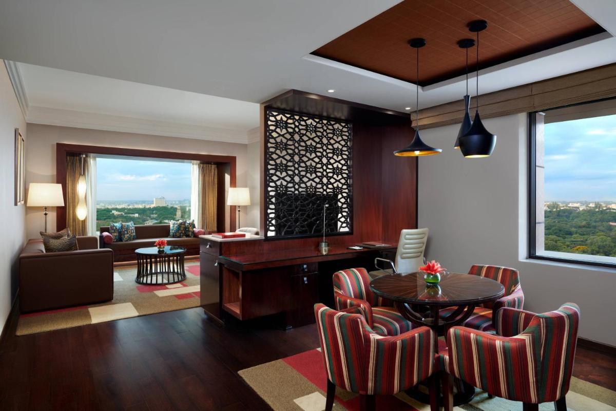 a living room with a table and chairs at JW Marriott Hotel Bengaluru in Bengaluru