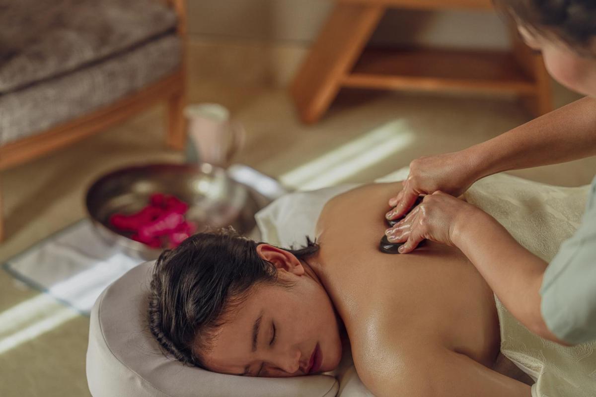 a woman getting a massage at a spa at The Westin Resort & Spa Himalayas in Rishīkesh