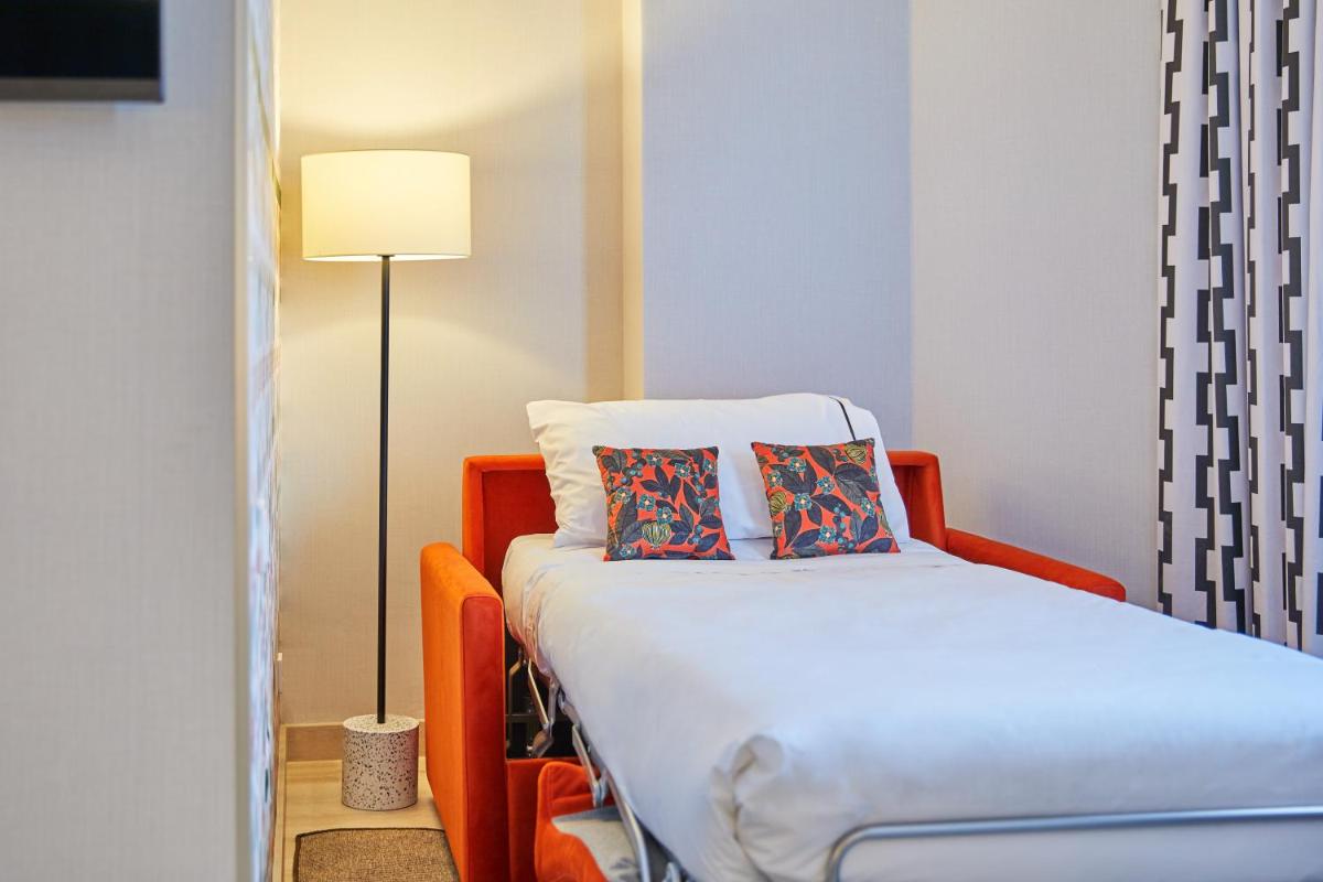 Cama o camas de una habitación en Hesperia Sevilla
