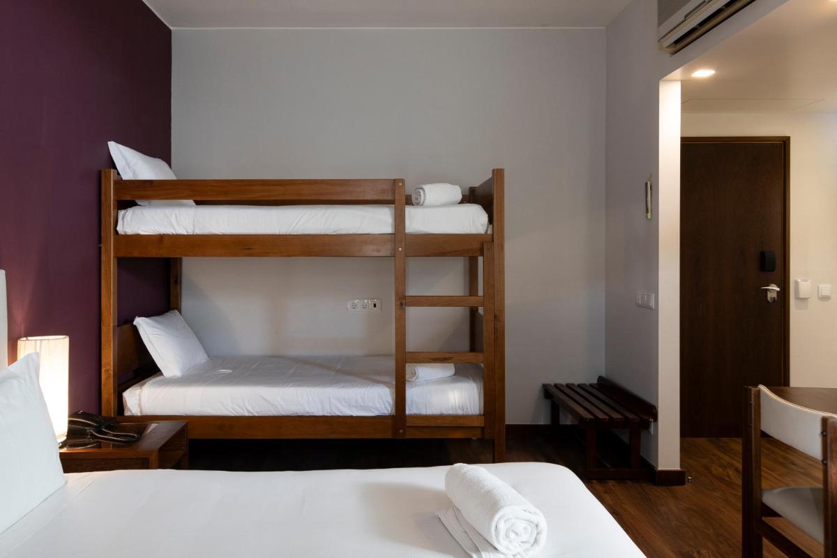 Uma cama ou camas num quarto em Hotel Rali Viana