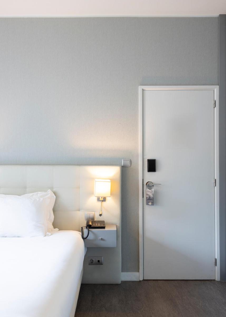 Uma cama ou camas num quarto em Hotel Rali Viana