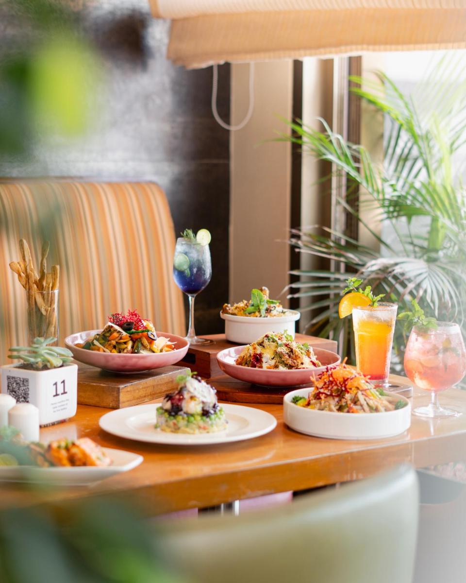 a table with four plates of food on it at Hyatt Place Pune Hinjawadi in Pune