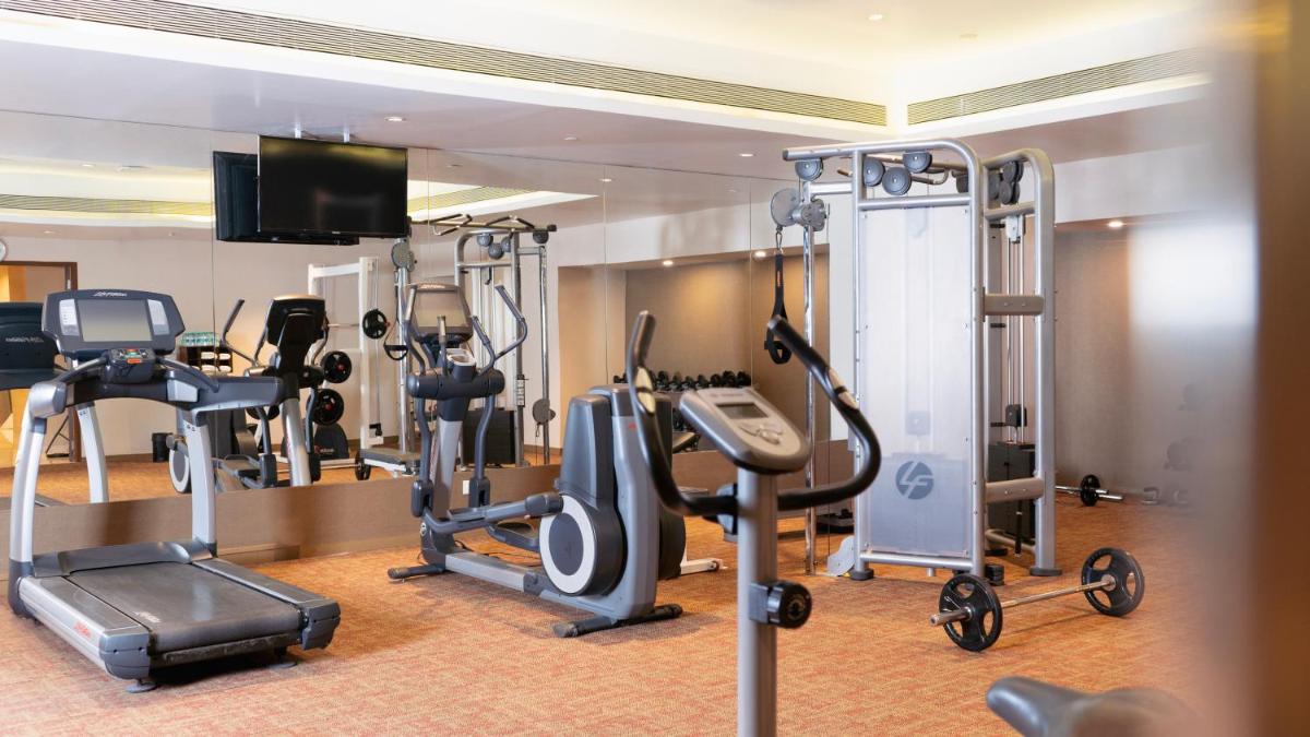 a gym with cardio equipment in a hotel room at Hyatt Place Pune Hinjawadi in Pune