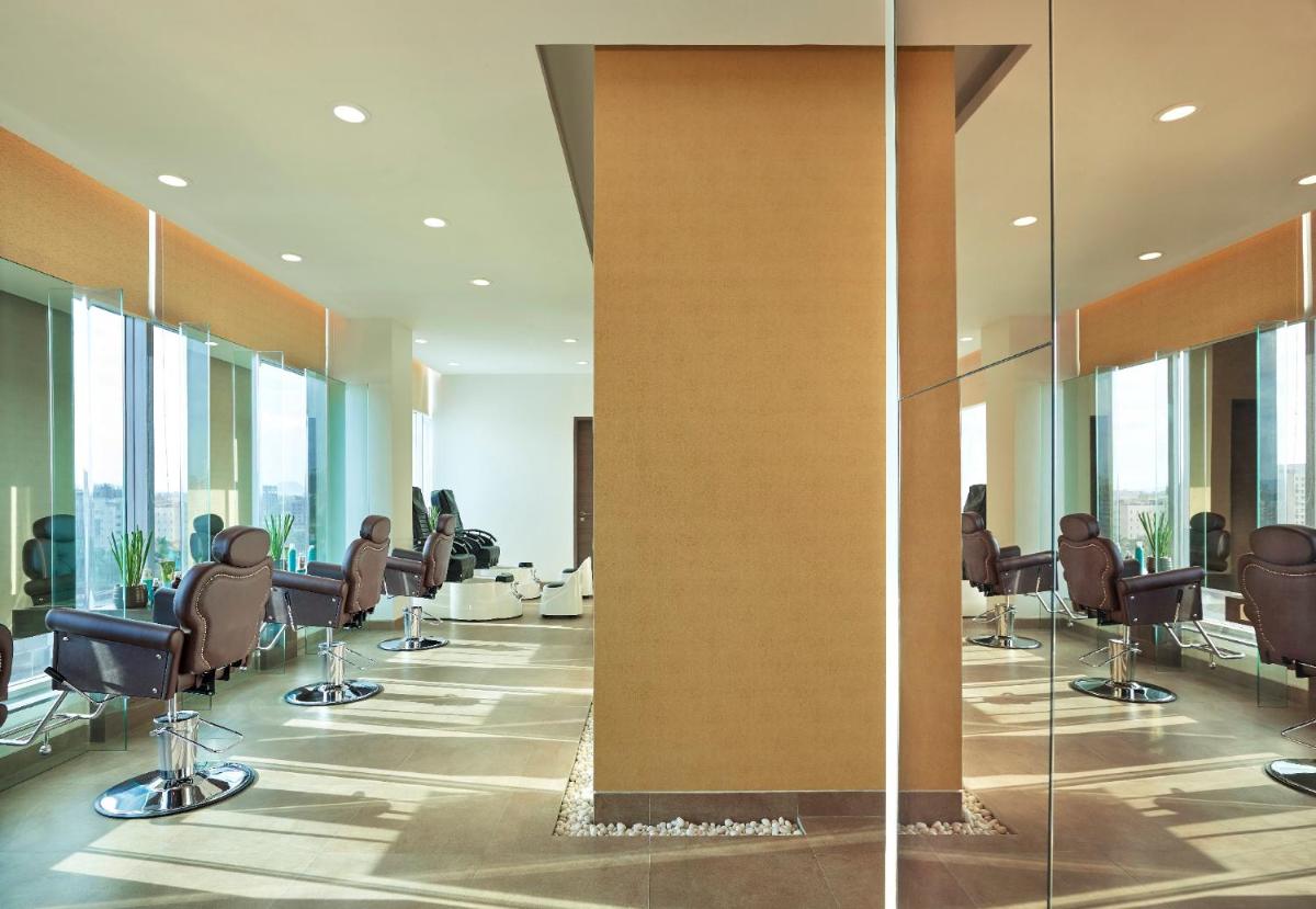a conference room with chairs and a wall of glass at Vivanta Pune, Hinjawadi in Pune