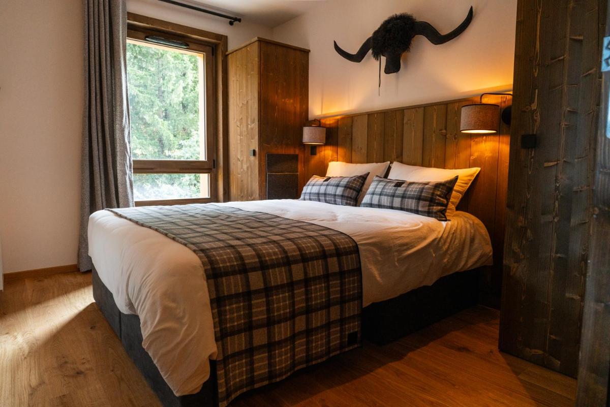 Un ou plusieurs lits dans un hébergement de l'établissement Résidence l'Ecrin d'Argent by My Mountain Resort