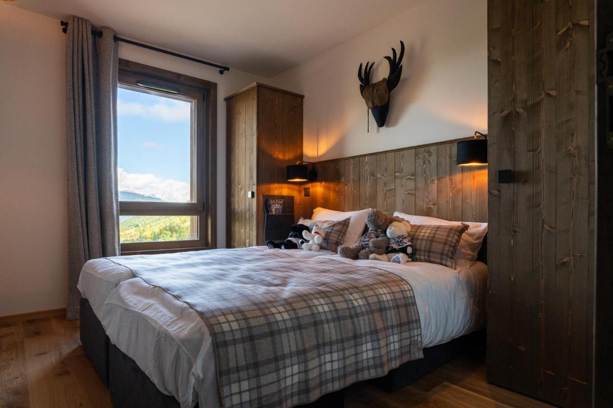 Un ou plusieurs lits dans un hébergement de l'établissement Résidence l'Ecrin d'Argent by My Mountain Resort
