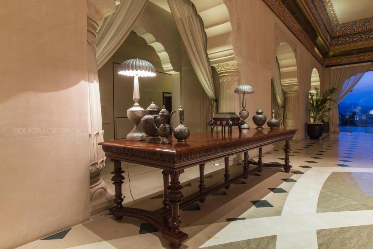 a table in a hallway with vases on it at Fairmont Jaipur in Jaipur
