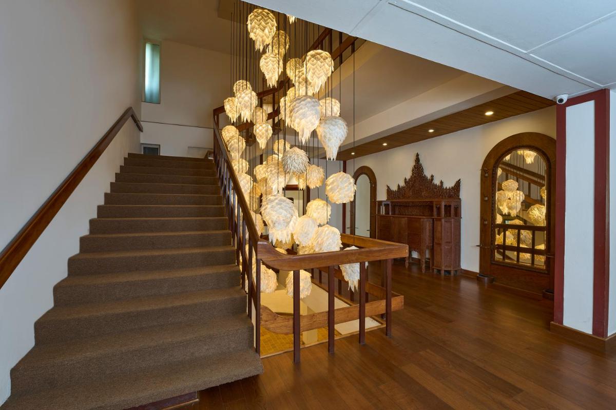 a staircase in a home with a display of balls at Casino Hotel - CGH Earth, Cochin in Cochin