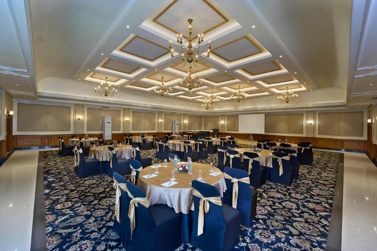 a banquet hall with tables and chairs in a room at Casino Hotel - CGH Earth, Cochin in Cochin