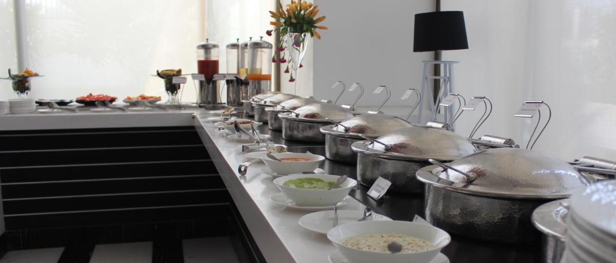 a row of pots and pans in a kitchen at Saura Hotel, Agra - A Club Mahindra Associate in Agra