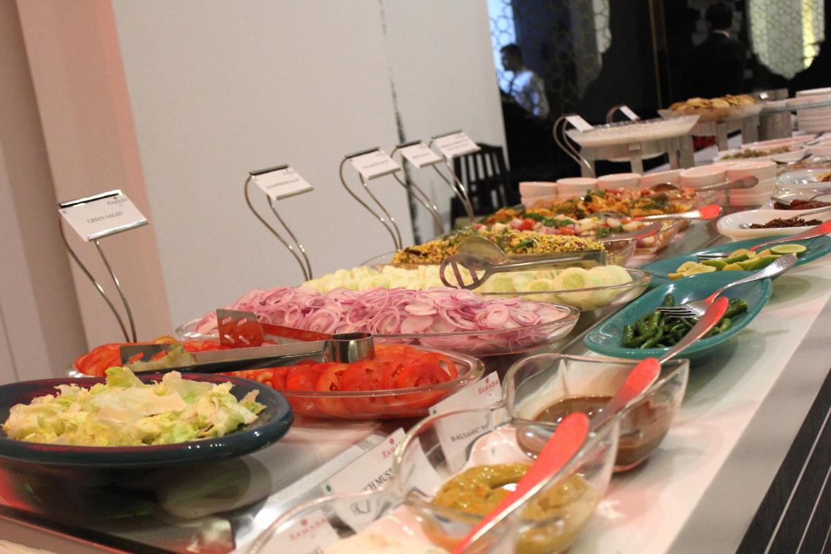 a buffet line with bowls of food on a table at Saura Hotel, Agra - A Club Mahindra Associate in Agra