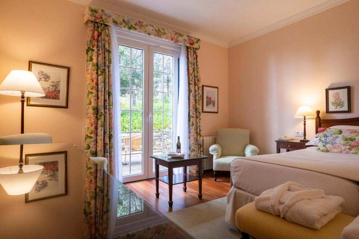 Uma cama ou camas num quarto em Casa Velha do Palheiro Relais & Chateaux