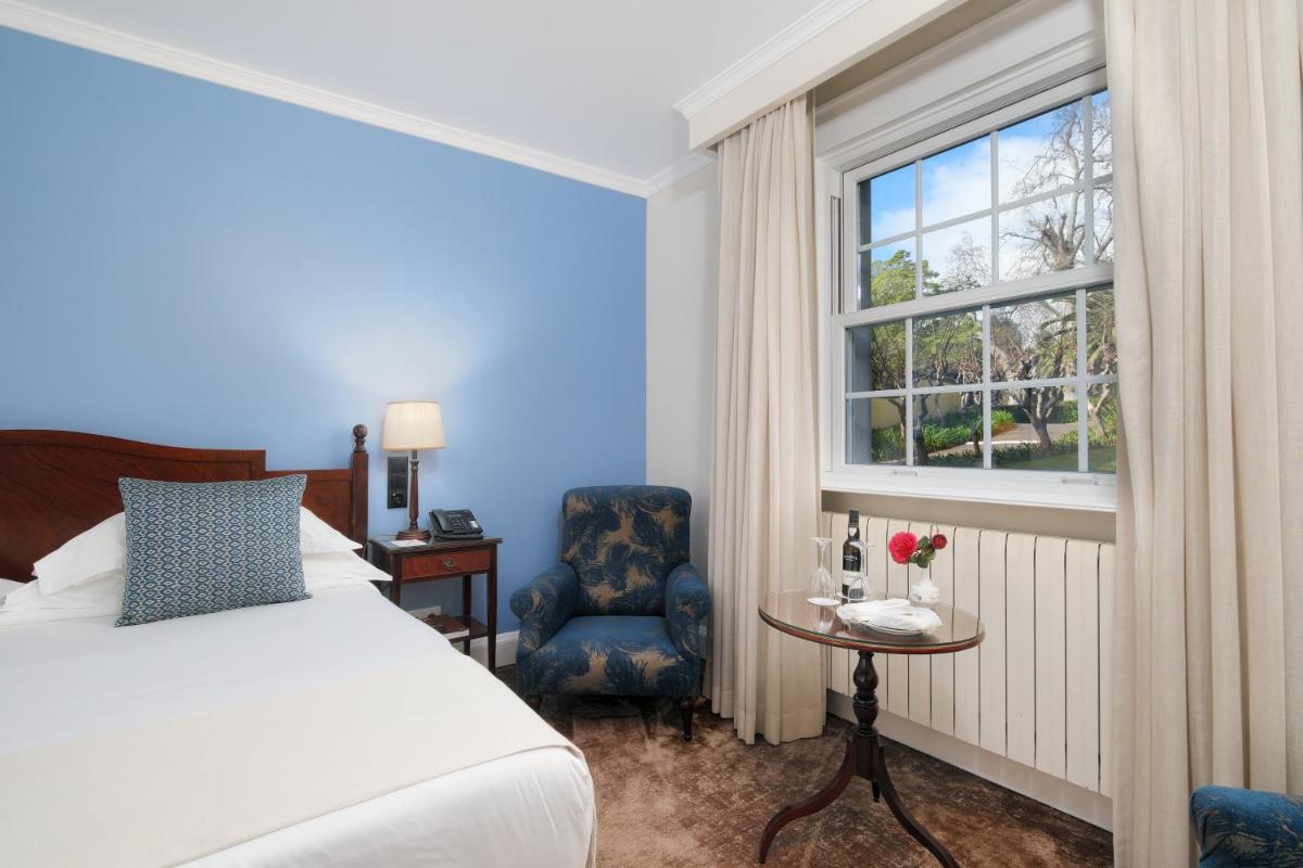 Uma cama ou camas num quarto em Casa Velha do Palheiro Relais & Chateaux