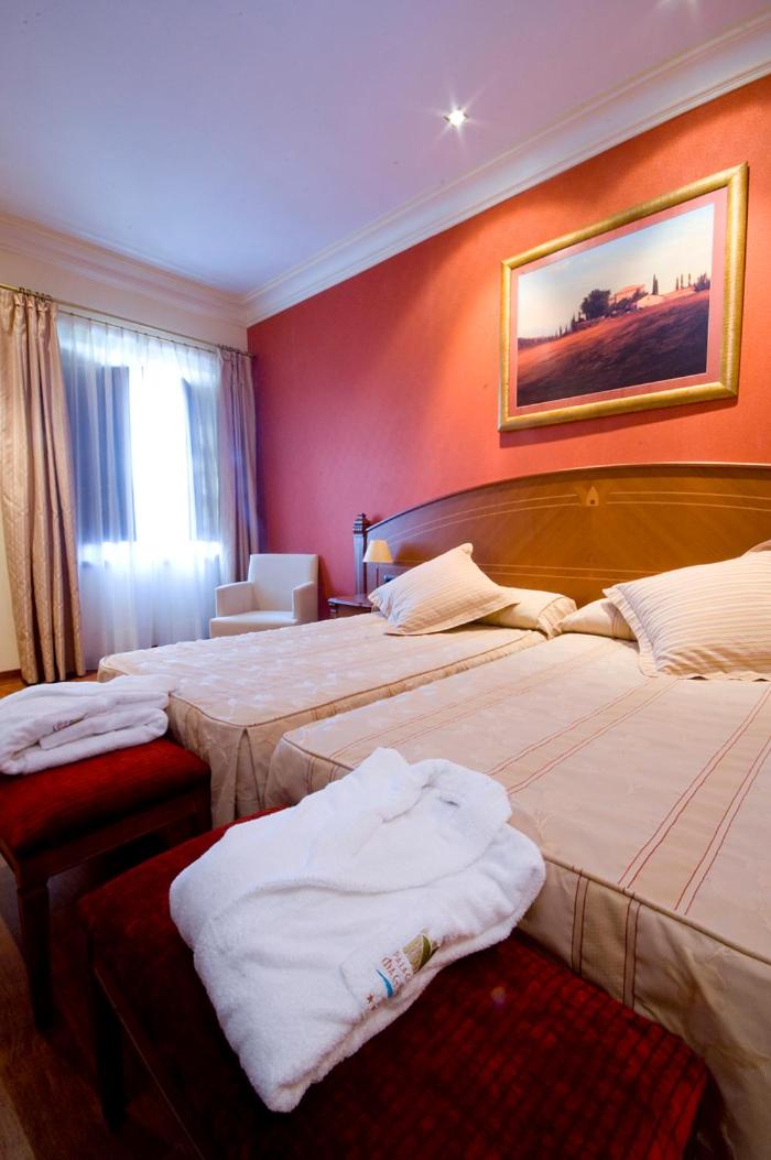 Cama o camas de una habitación en Hotel Palacio de la Magdalena
