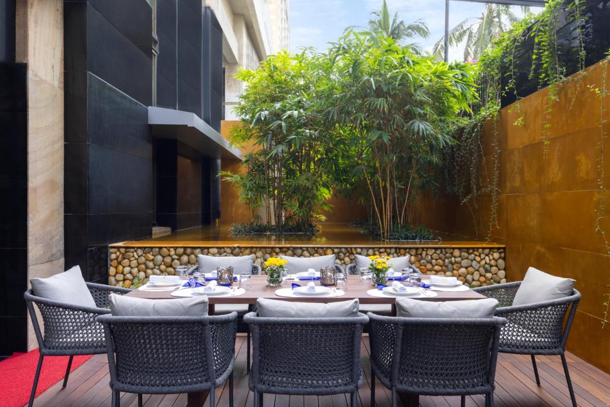 a restaurant with a table and chairs on a patio at Trident Nariman Point in Mumbai a restaurant with a table and chairs on a patio at Trident Nariman Point in Mumbai