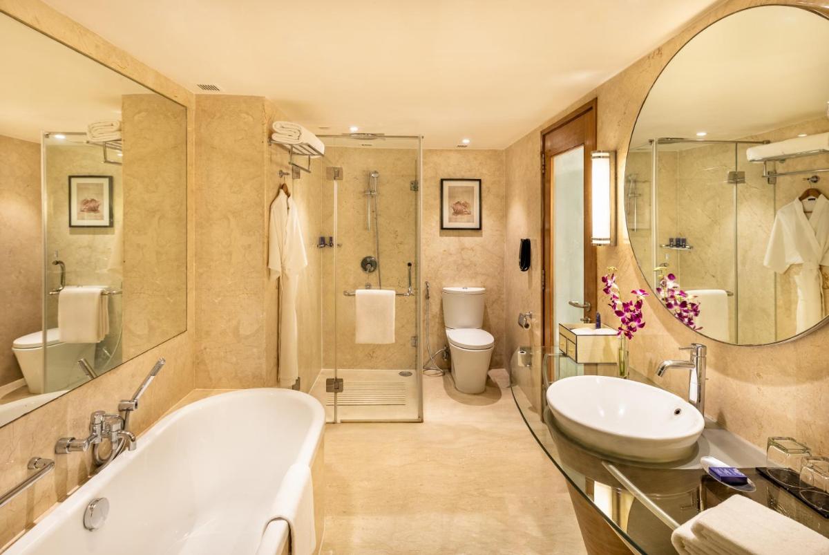 a bathroom with a tub and a sink and a shower at Vivanta Goa, Panaji in Panaji a bathroom with a tub and a sink and a shower at Vivanta Goa, Panaji in Panaji