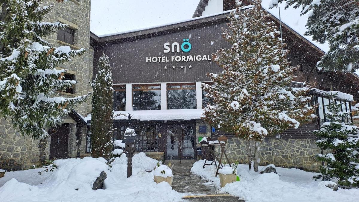 un hotel en la nieve frente a un edificio en Snö Hotel Formigal, en Formigal