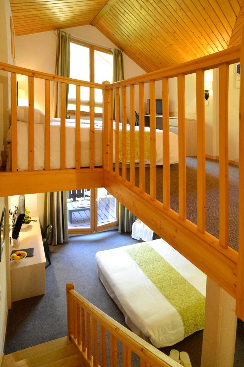 Un ou plusieurs lits dans un hébergement de l'établissement Le Bois Dormant-Hôtel Restaurant & Spa Logis Hôtel