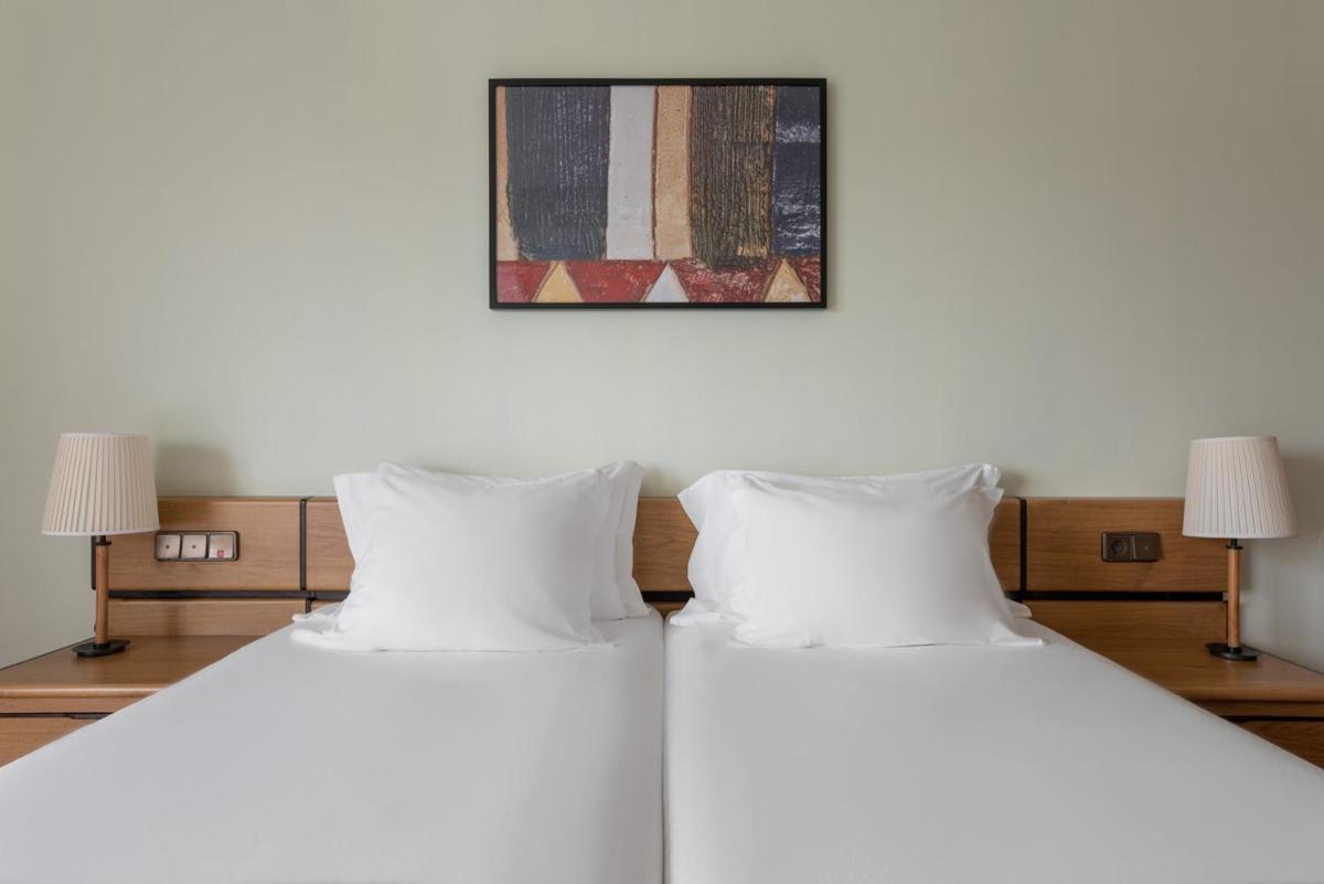 Uma cama ou camas num quarto em Dorma Praia Golfe