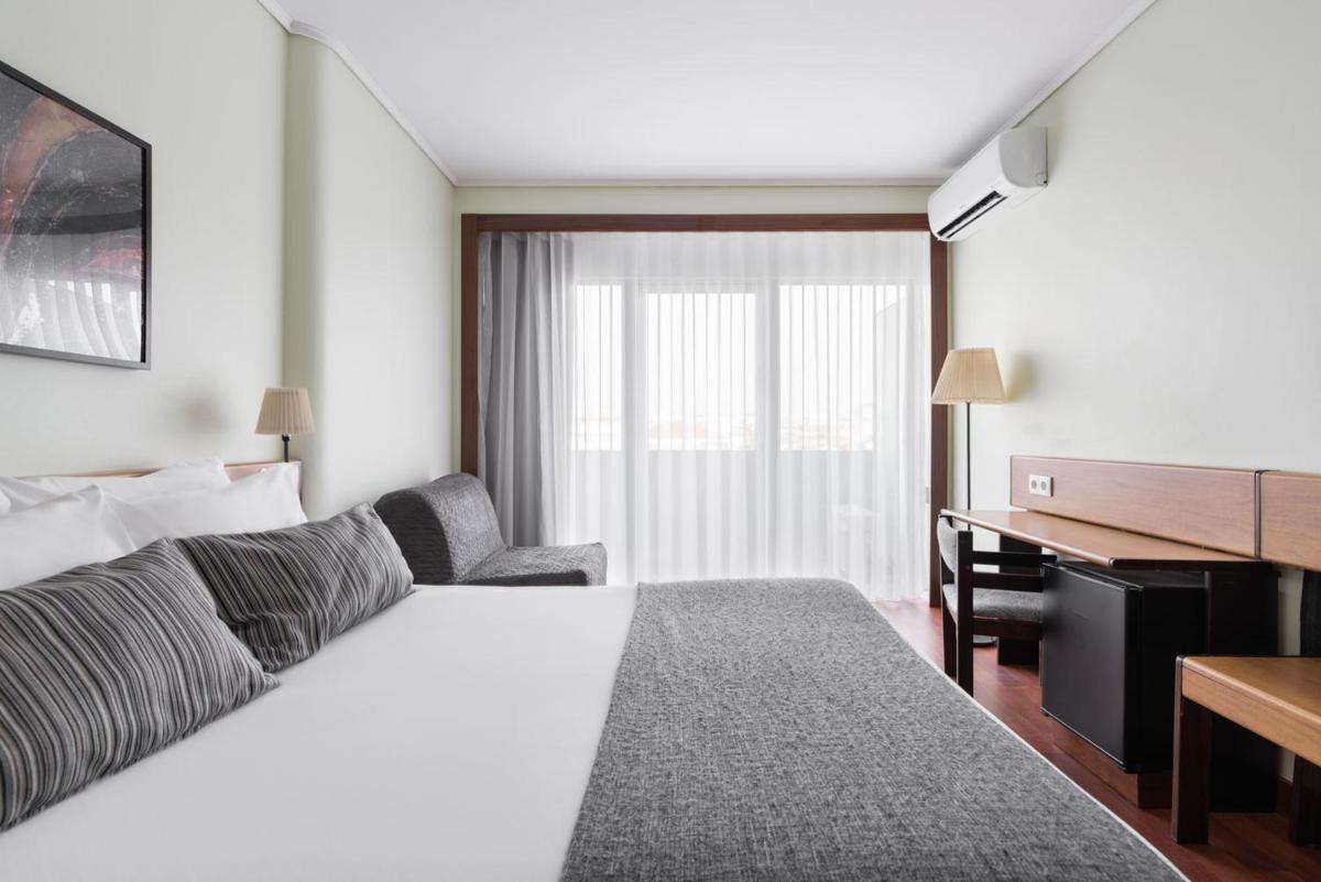 Uma cama ou camas num quarto em Dorma Praia Golfe